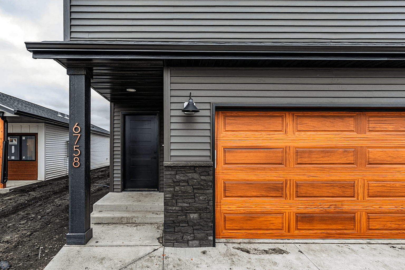 Long raised panel garage doors in cedar accents