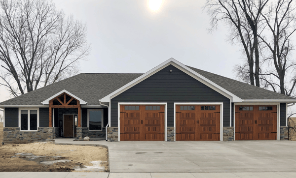 Stamped carriage house garage door in cedar accents woodtones faux wood on one level ranch style home Spalted Oak Ashlar