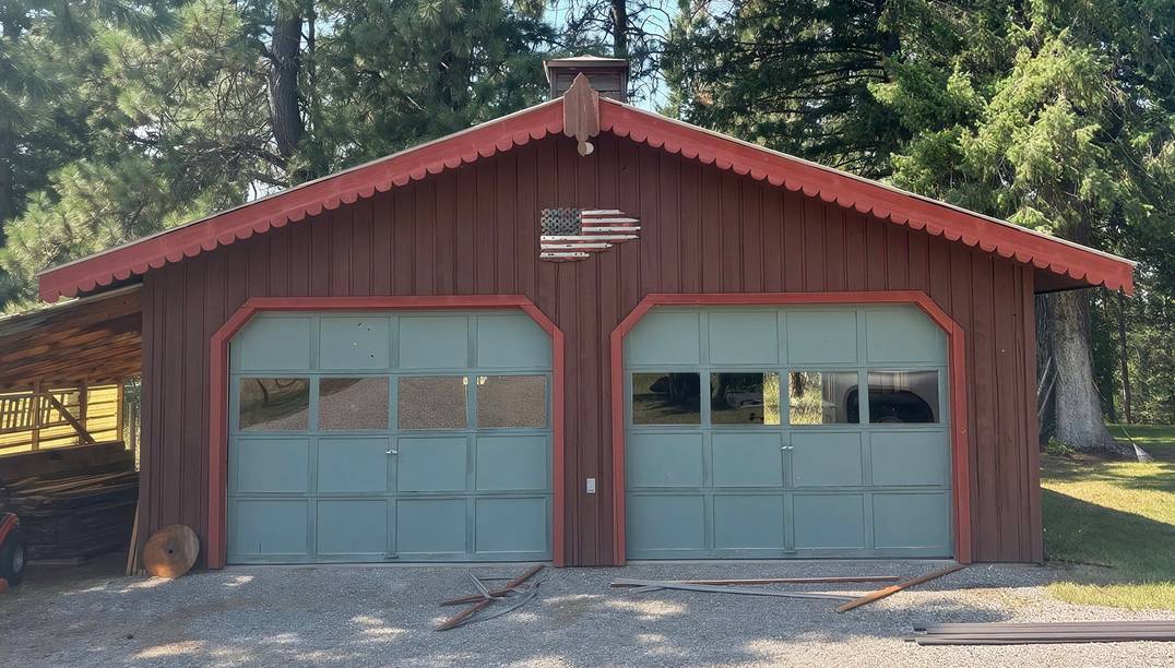 before - red garage with two old doors