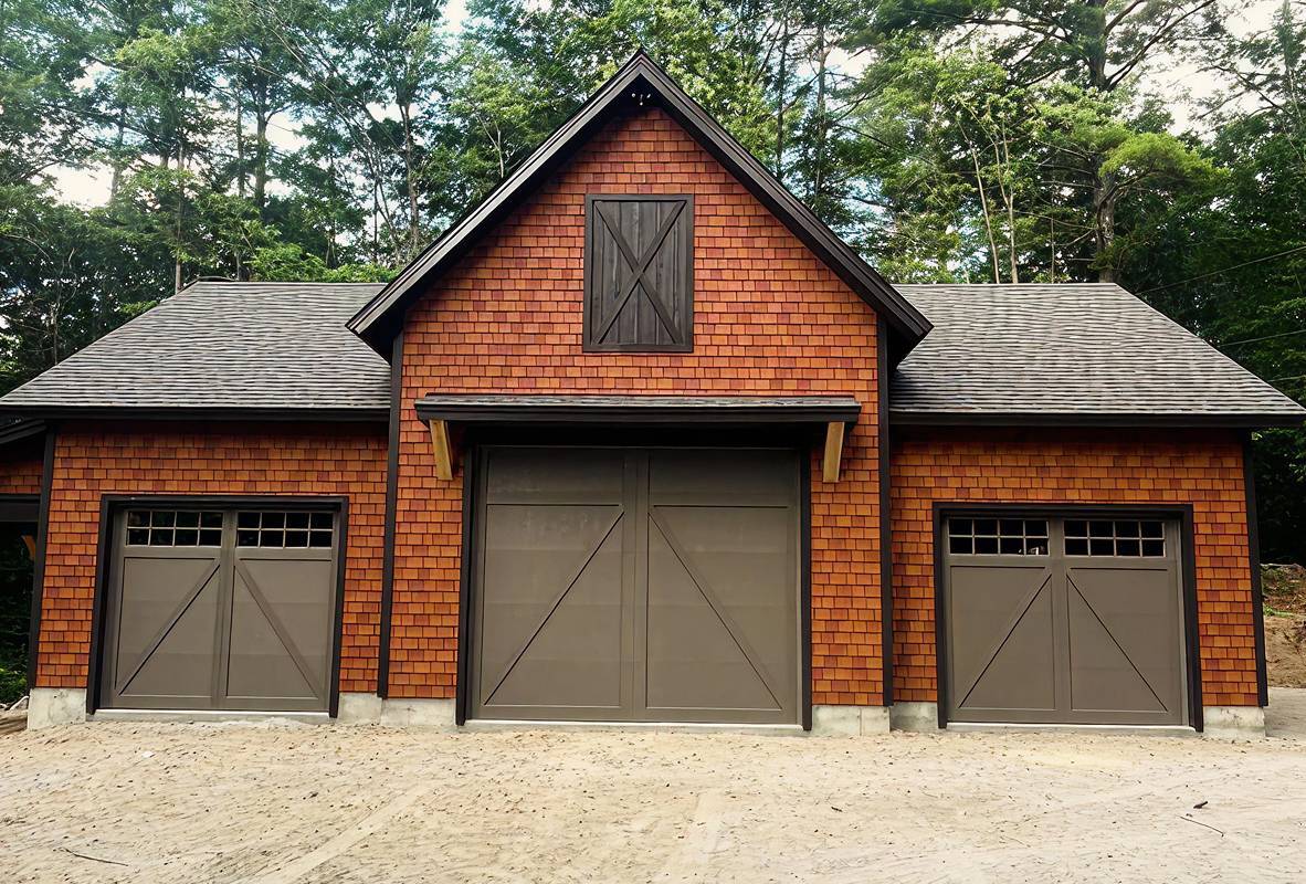 Red color brick house with three bronze garage doors