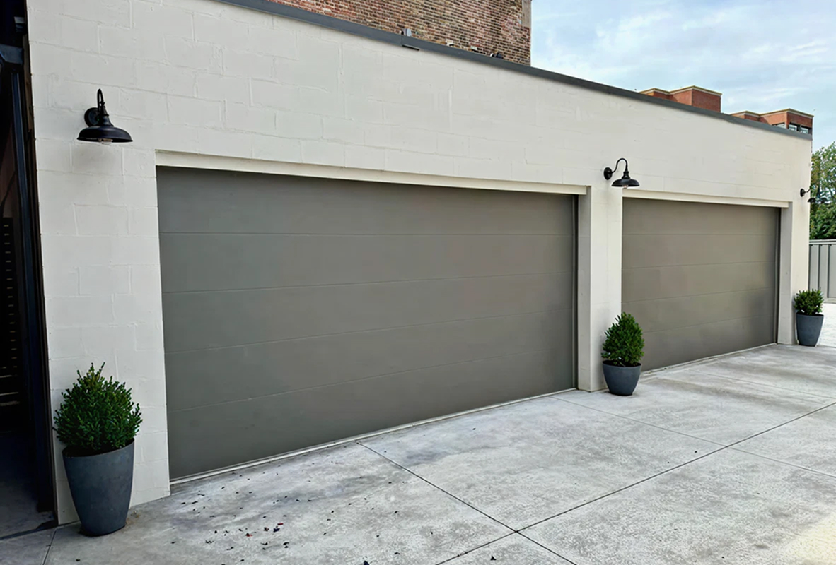 White house with two bronze garage doors