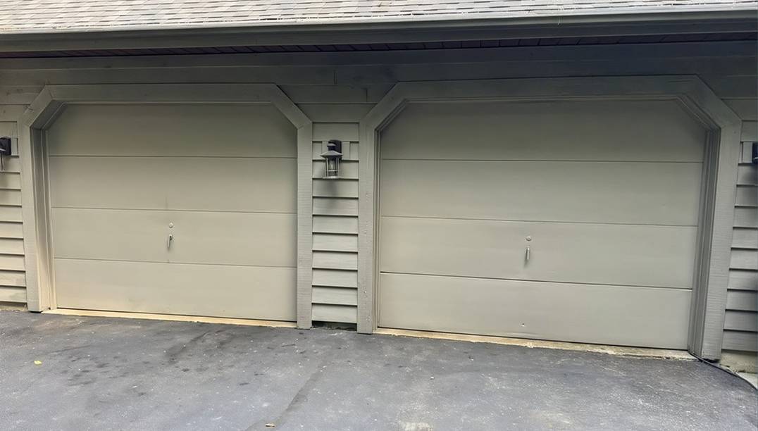 before - white paneled garage with two old doors