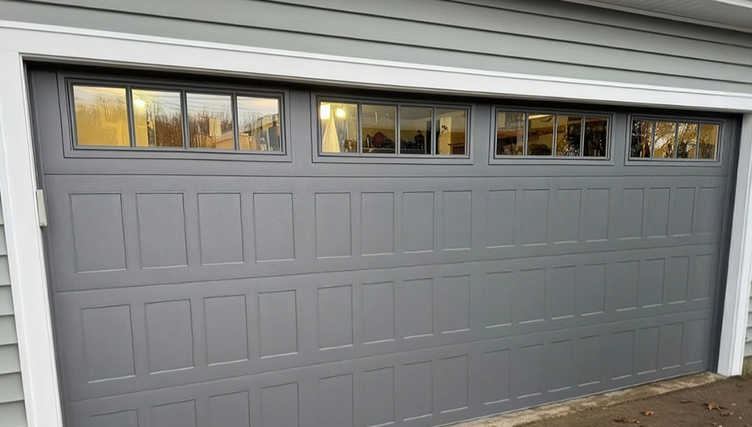 after - gray house with graphite gray stamped shaker garage door
