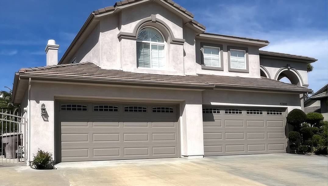 after -  two new raised panel sandstone garage doors