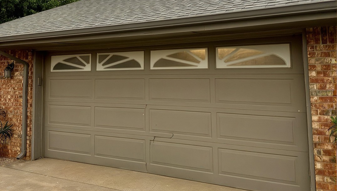 before - brick house with a cracked garage door