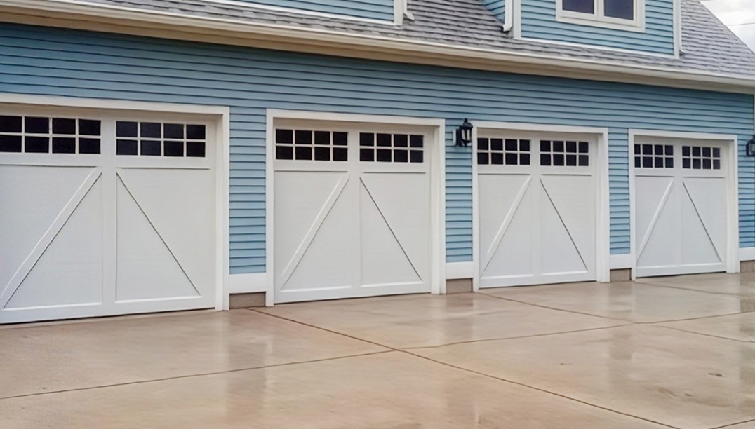 after -  blue home with white garage doors - Steel Overlay Carriage House