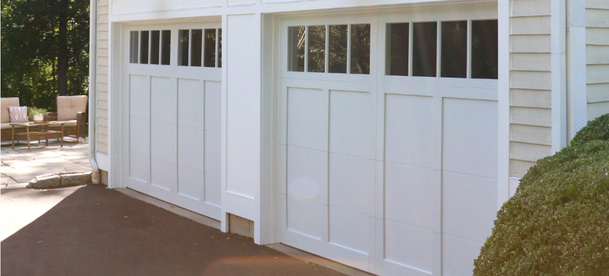 Overlay carriage house garage door in white cottage house