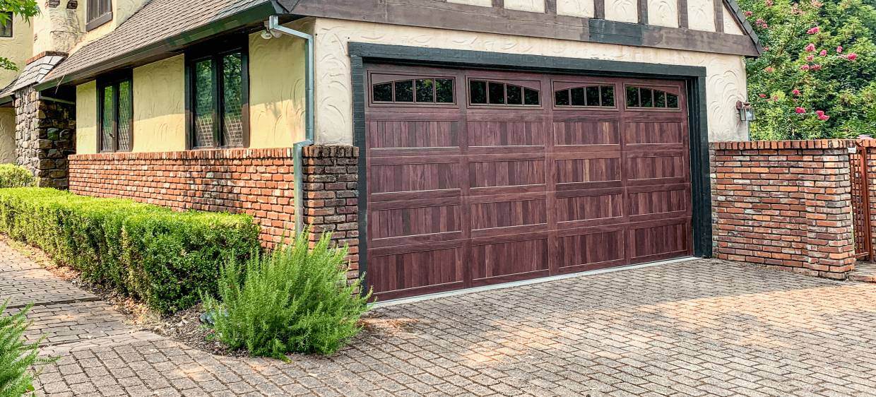 Stamped carriage house garage door in mahogany cottage style house