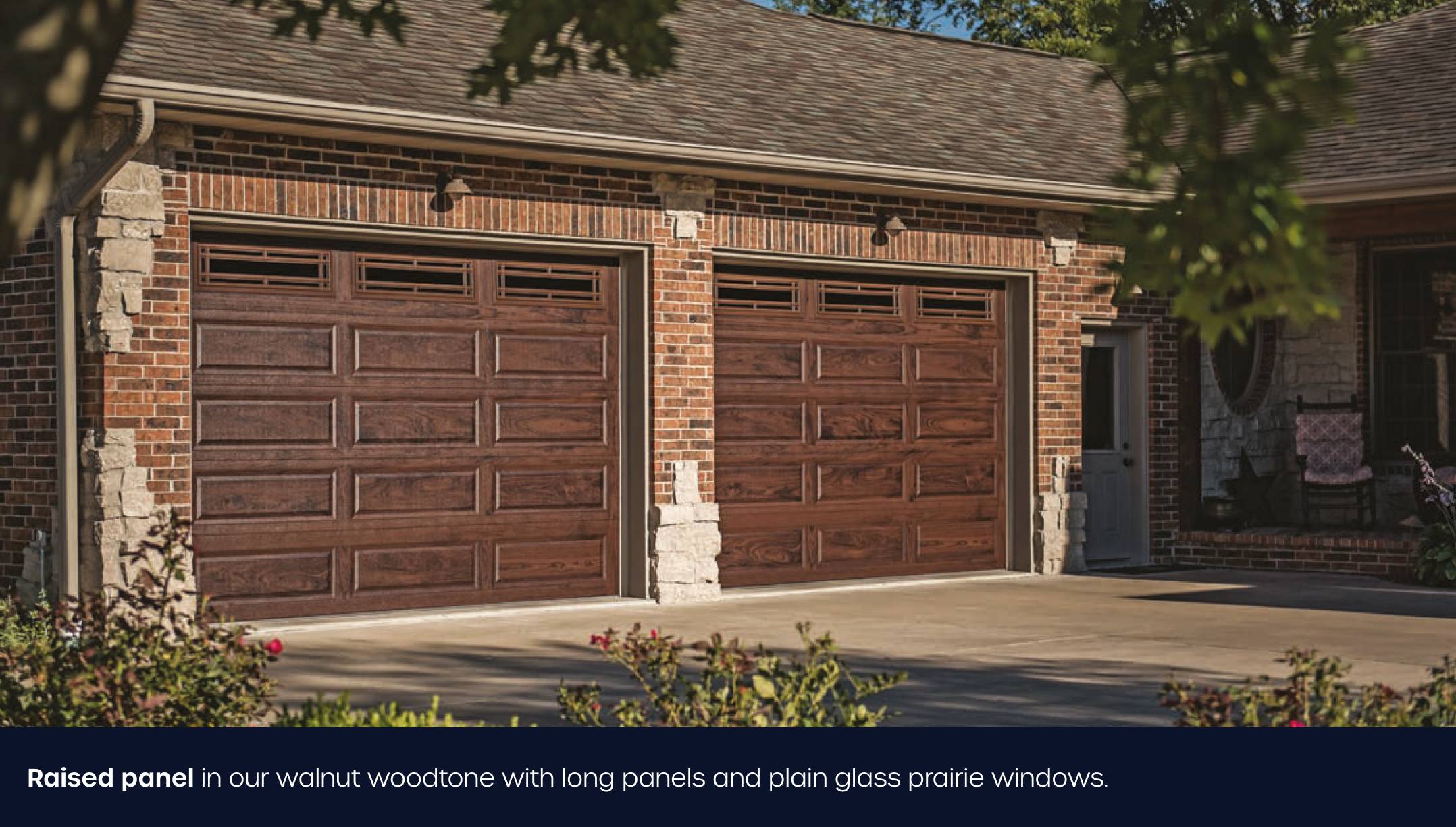 Long raised panel garage door in walnut and plain glass windows