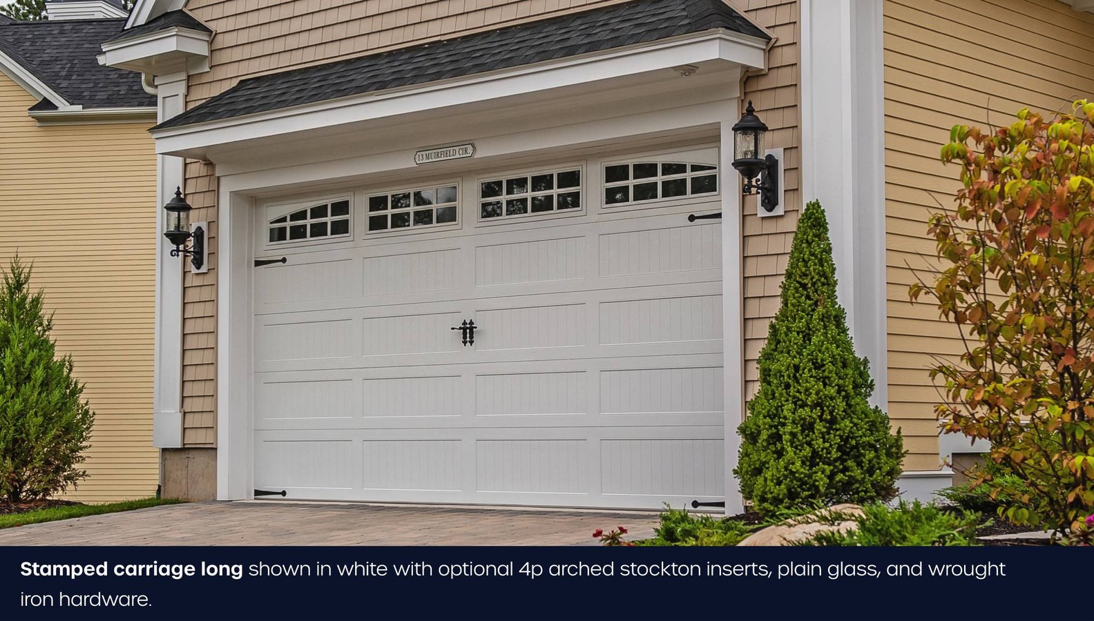 C.H.I. long stamped carriage house door in white with arched windows and decorative hardware