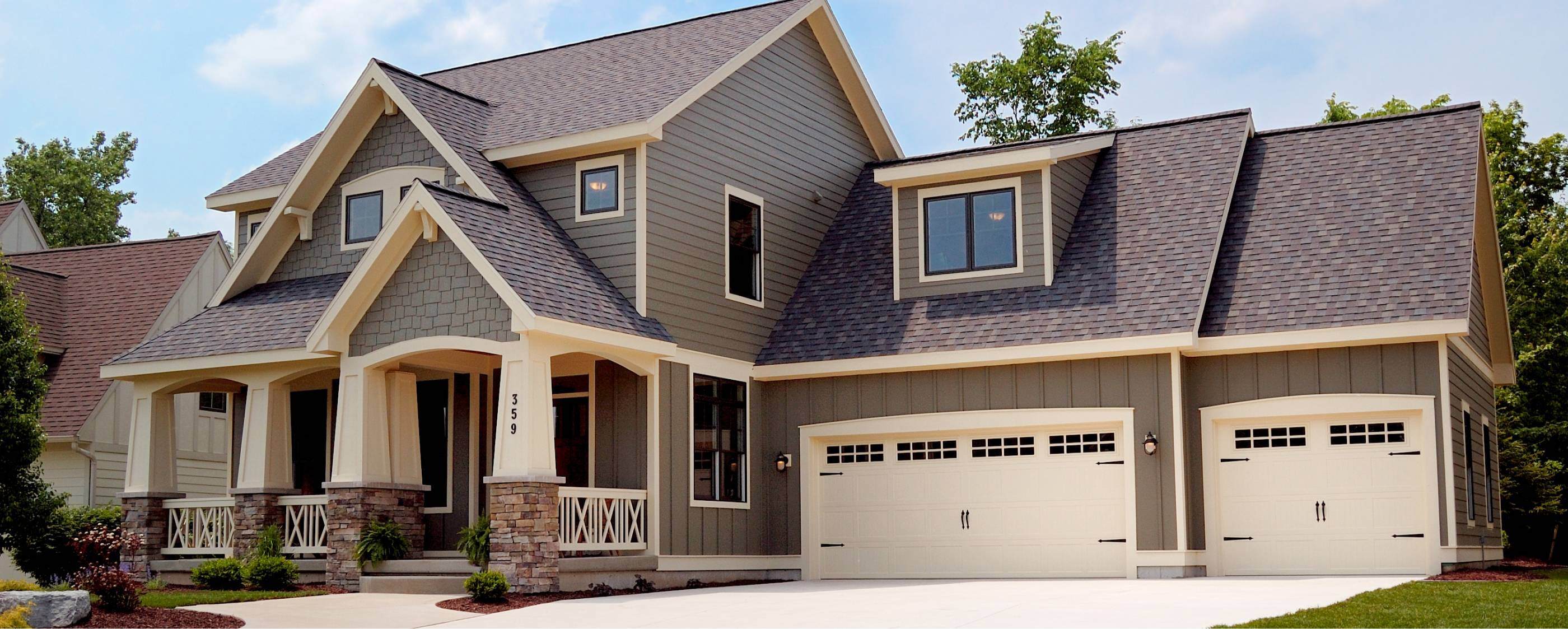 Stamped carriage house garage door in almond