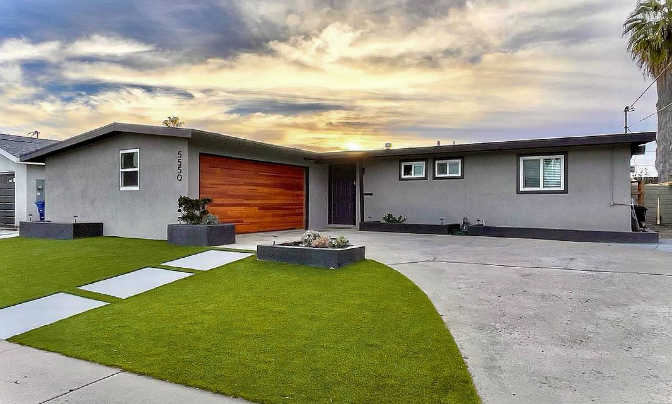 Wood look garage door with grey house