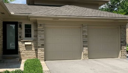 Beige recessed panel residential garage doors - Before