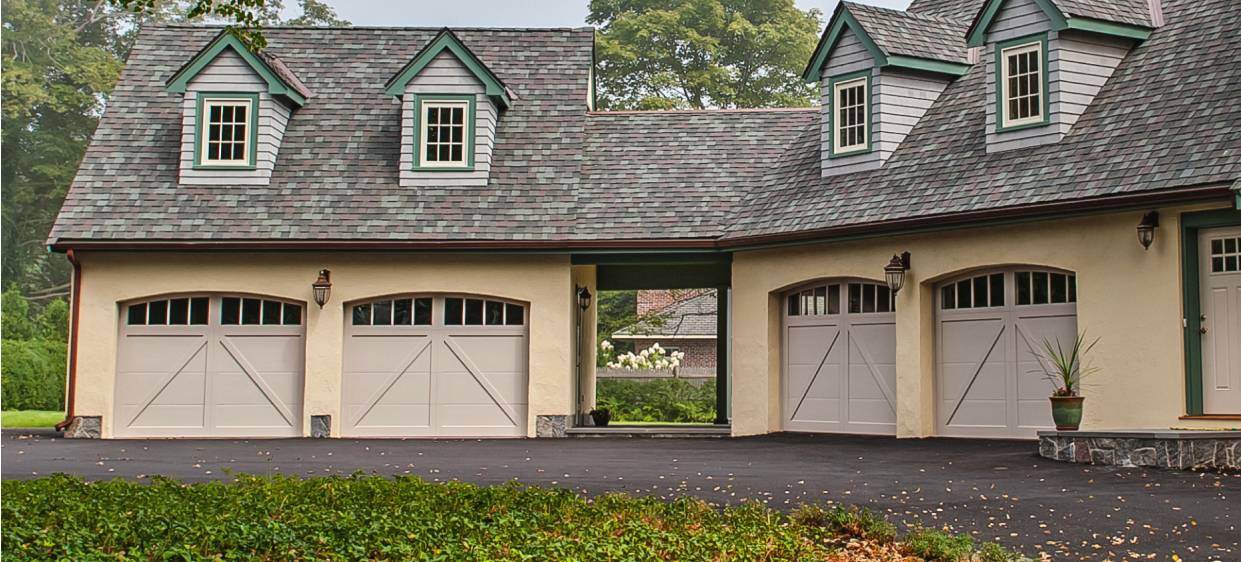 Overlay carriage house garage door in almond tudor style house