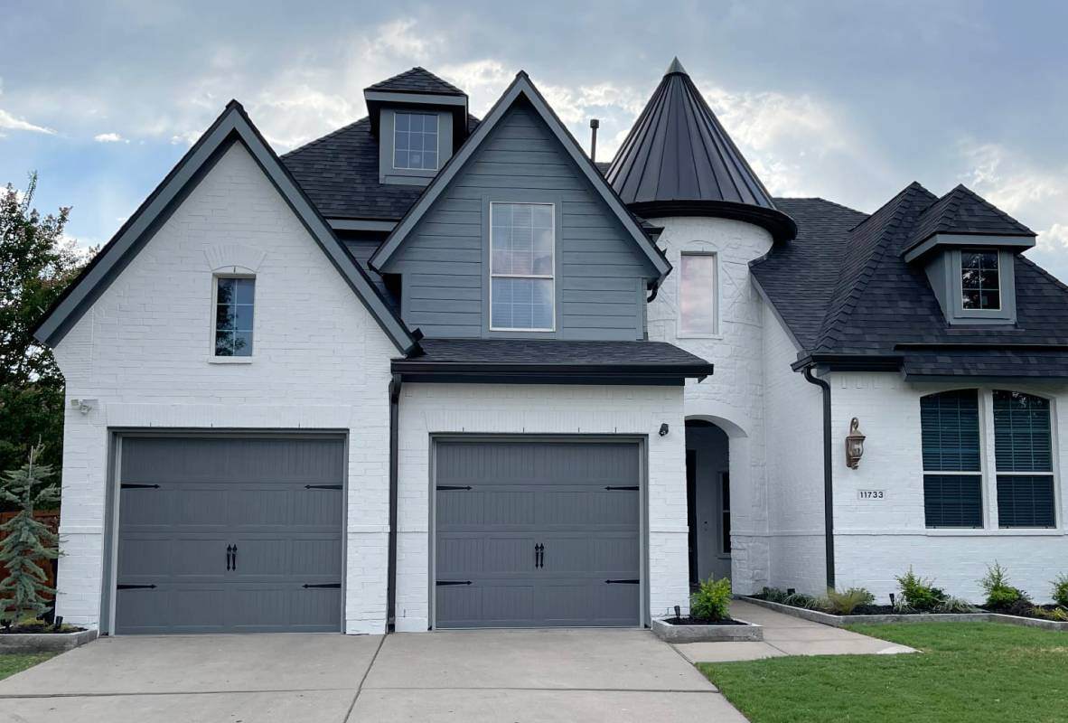 Stamped carriage house garage doors in graphite modern tudor style