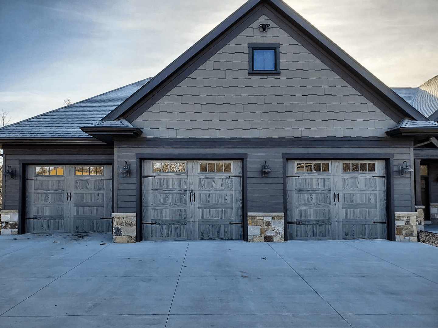 stamped carriage house garage doors in driftwood accents